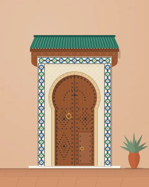 A cedar door in a horseshoe arch, framed by a band of zellige tilework and sheltered by a small green-tiled roof, with potted plants beside it.