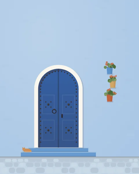 A studded blue door with a white-washed arch on a pale blue wall, potted geraniums hung beside it and a ginger cat asleep on the step.