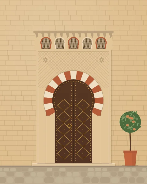 A studded wooden door in a horseshoe arch of alternating red and cream voussoirs, set in a carved frame under a row of small latticed arches.