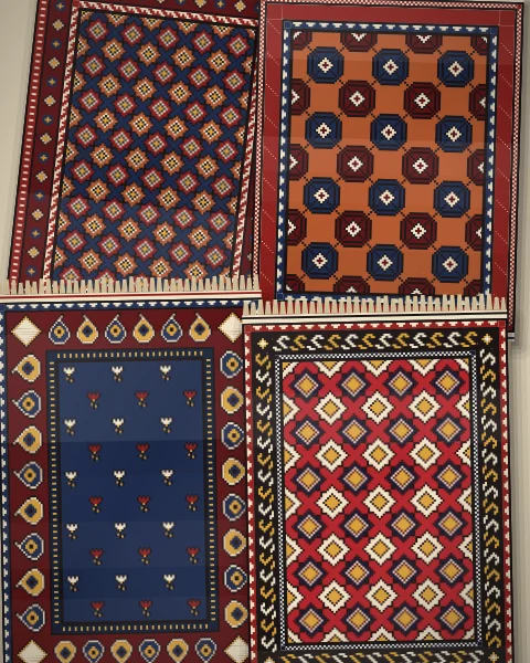 Small rugs laid out in two loose columns on pale plaster, each with its own field of stars, Memling guls or sprigs and its own border.