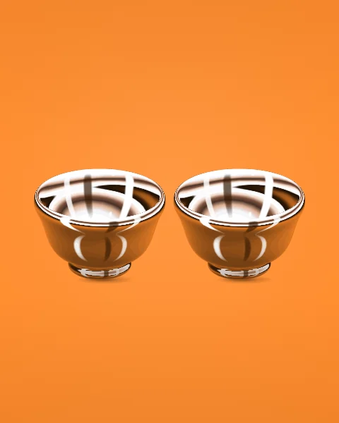 Two small chrome coffee cups stand side by side on a tangerine ground, their insides catching bright bands of studio light.