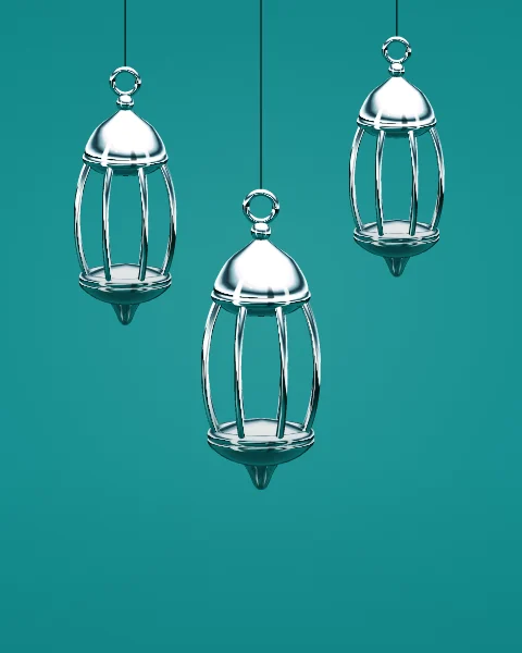 Three chrome lanterns hang at different heights from fine cords on a deep teal ground.