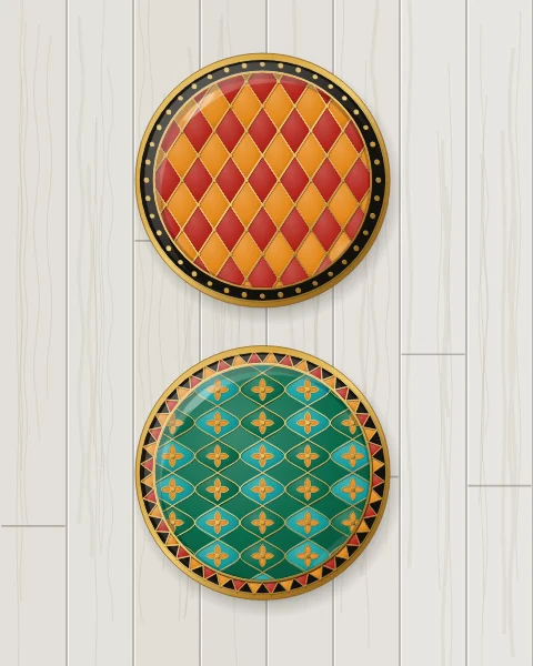 Two enamel plates: one carnelian with a harlequin lattice of saffron diamonds, one emerald with an ogival net of turquoise and small gold flowers, on grey-washed boards.