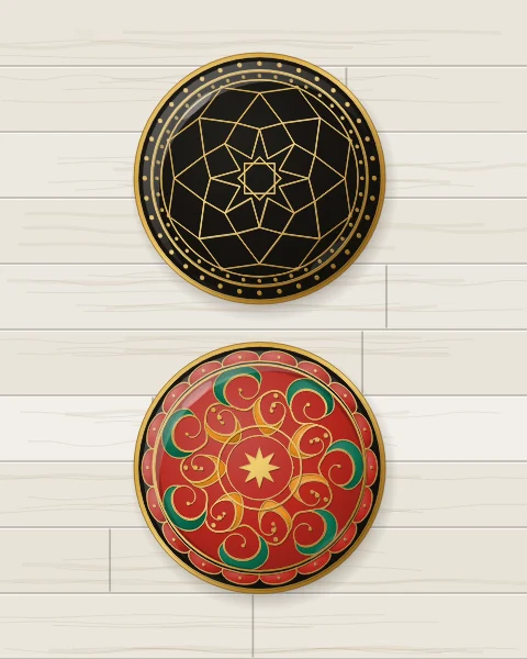 Two enamel plates drawn mostly in raised gold line: a black one with an eight-pointed rosette of gold petals and kites, and a carnelian one circled by a gold scrolling vine with saffron and emerald leaves around a gold star.