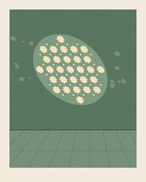 A round window fitted with an iron grille of eight-point stars throws its pattern on a deep green wall, as a soft disc of light pierced with small bright stars.