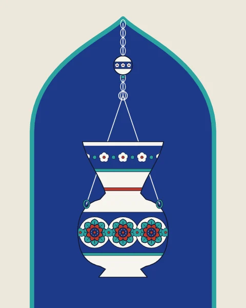 A white ceramic mosque lamp with bands of rosettes and blossoms hangs on chains in a cobalt niche, with a small hanging ball above it.
