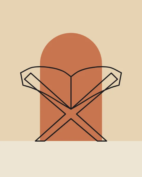 An open Quran resting on a rehal, the folding X-shaped stand, in front of a terracotta arch. The pages are left blank.
