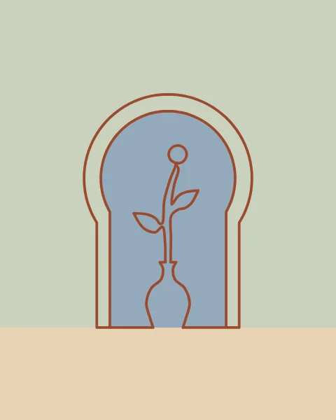 A horseshoe arch window with a small bud vase on the sill, its opening filled with dusty blue sky.