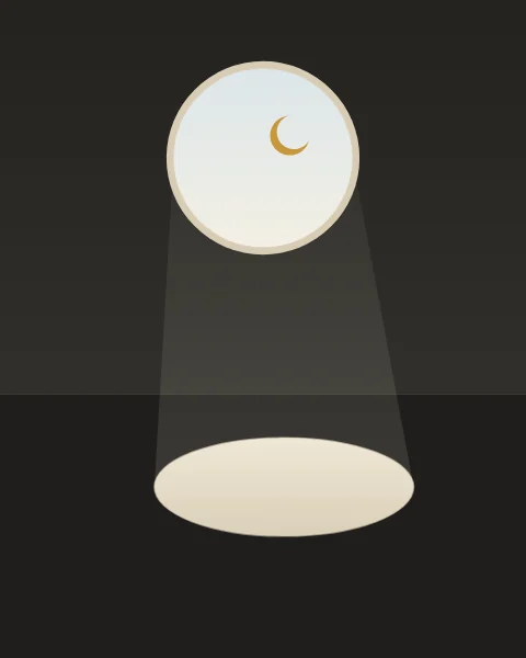 A round opening high in a charcoal room shows a pale sky and a slim crescent. A faint beam falls from it to the dark floor, where the light lies as a long soft ellipse of cream.
