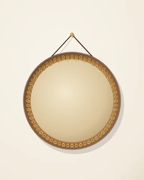 A large frame drum hangs from a brass peg by a leather cord, the rings fixed inside its frame catching the light.