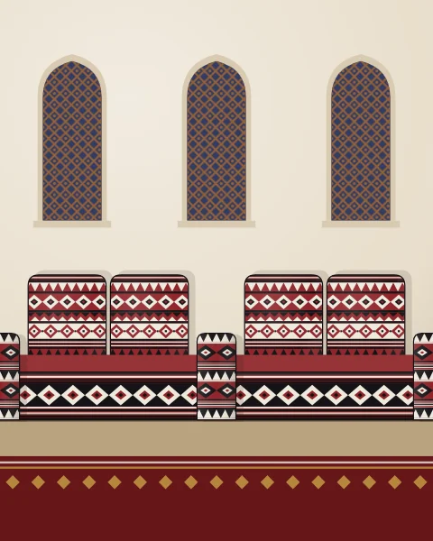 Floor cushions, back cushions and arm rests woven in red, black and ivory sadu line a plaster wall beneath latticed windows.