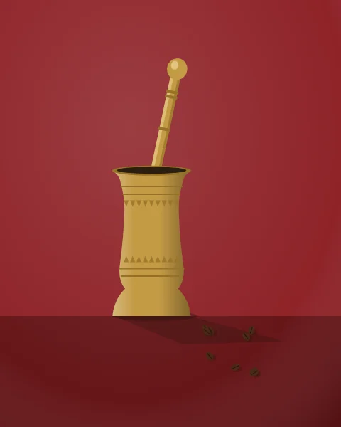 A tall brass coffee mortar with its pestle stands on a red ground, a few roasted beans scattered beside it.