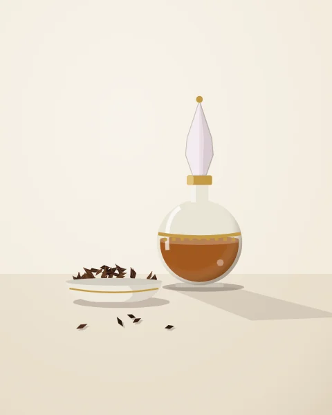 A round glass bottle of amber perfume oil with a tall stopper beside a dish of dark resinous wood chips.