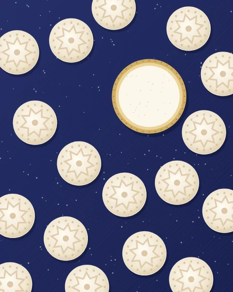 Round biscuits stamped with stars and thickly dusted with icing sugar, scattered across an indigo cloth beside a small brass dish of sugar.