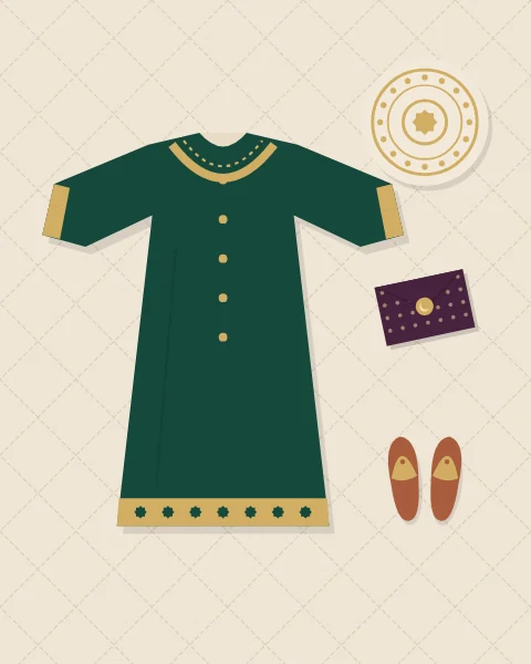 A child's new emerald tunic with gold embroidery at the yoke, cuffs and hem, laid flat on a quilted bone cover beside an embroidered cap, a pair of terracotta slippers and a small plum envelope.
