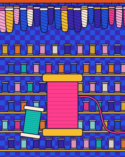 Walls of thread spools on rails, with twisted hanks of thread hanging from the top and a large pink spool in front.