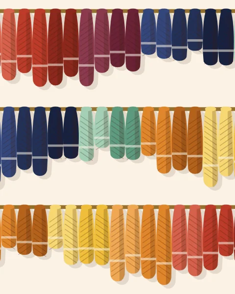 Twisted skeins of wool hung over poles to dry, grouped in runs of saffron, red, indigo and mint.