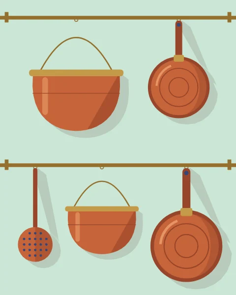Copper cauldrons, pans, a ewer and skimmers hang from rails against a pale mint wall.