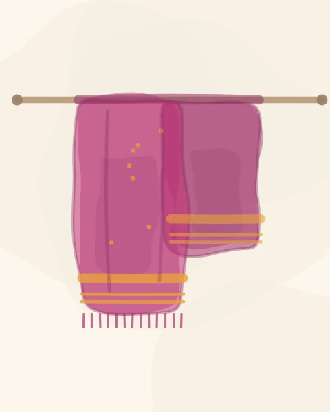 A single magenta shawl with saffron woven bands and a fringe, hanging over a wooden rail on a plain pale ground.