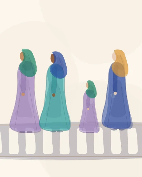 Women and a girl crossing a street on a zebra crossing, seen from the side, in bright robes, scarves and shawls.